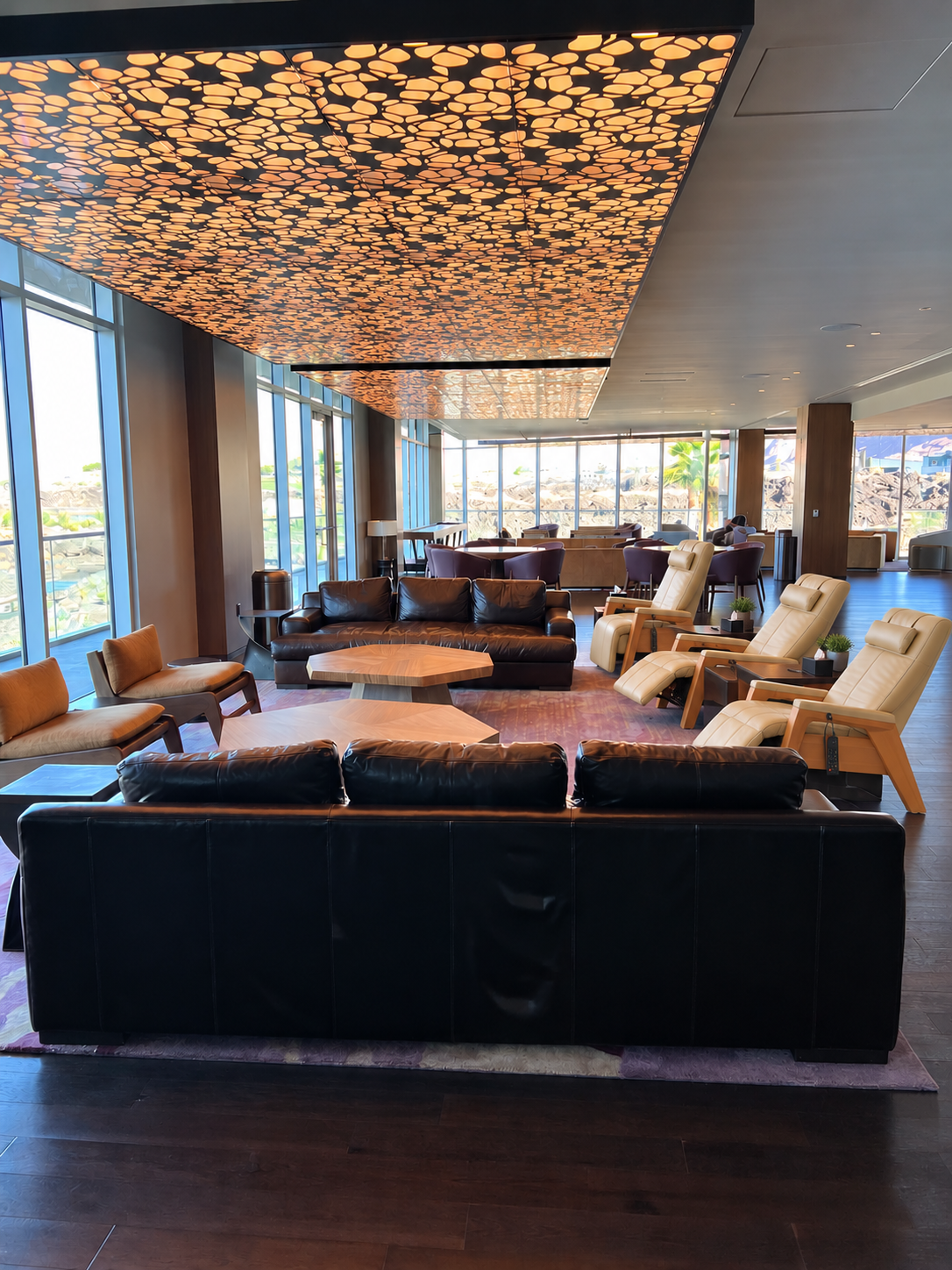 The Black Desert owners' lounge with Human Touch recovery recliners, leather seating, and canyon views
